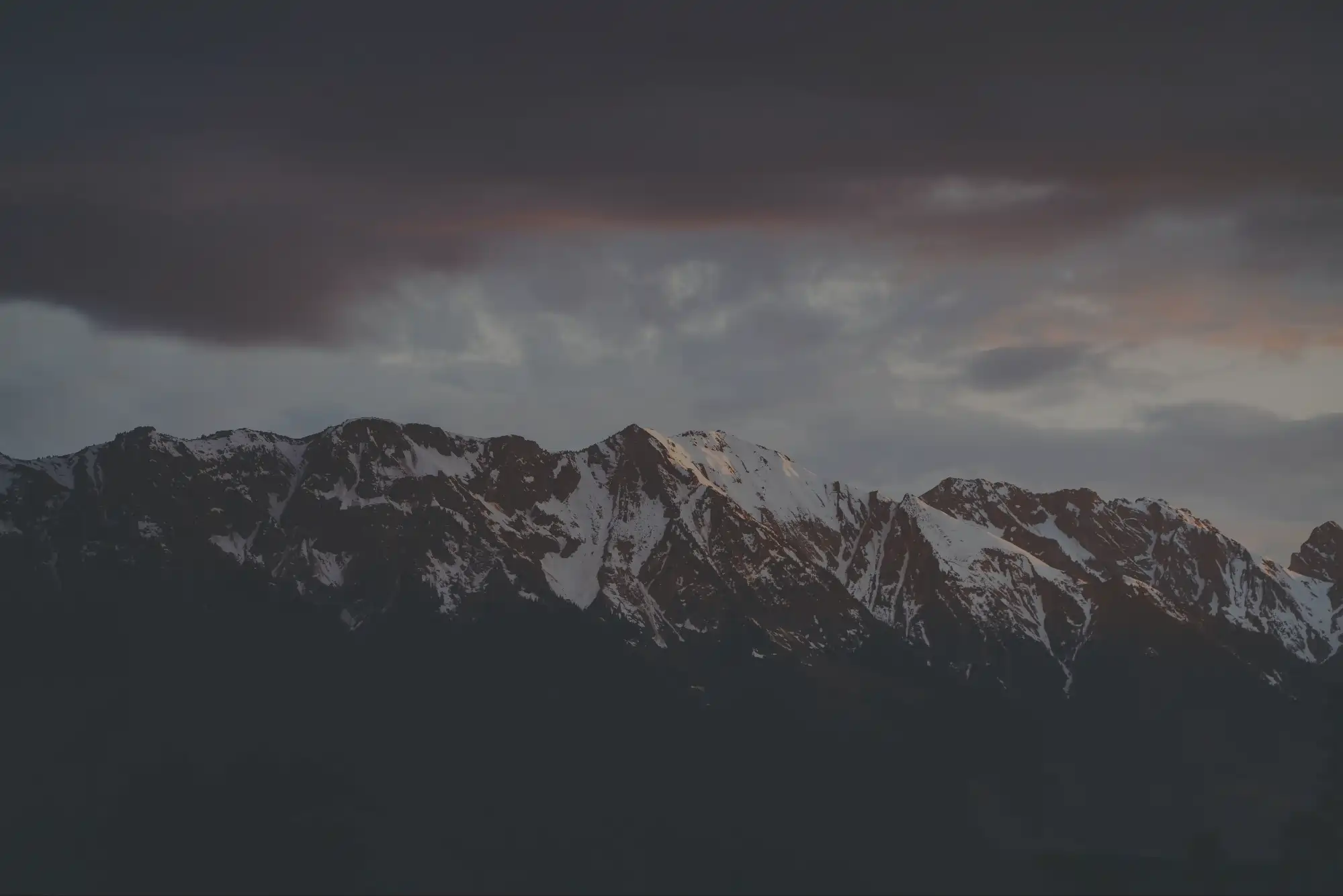 A scenic snowy landscape with vivid colors and tall mountains