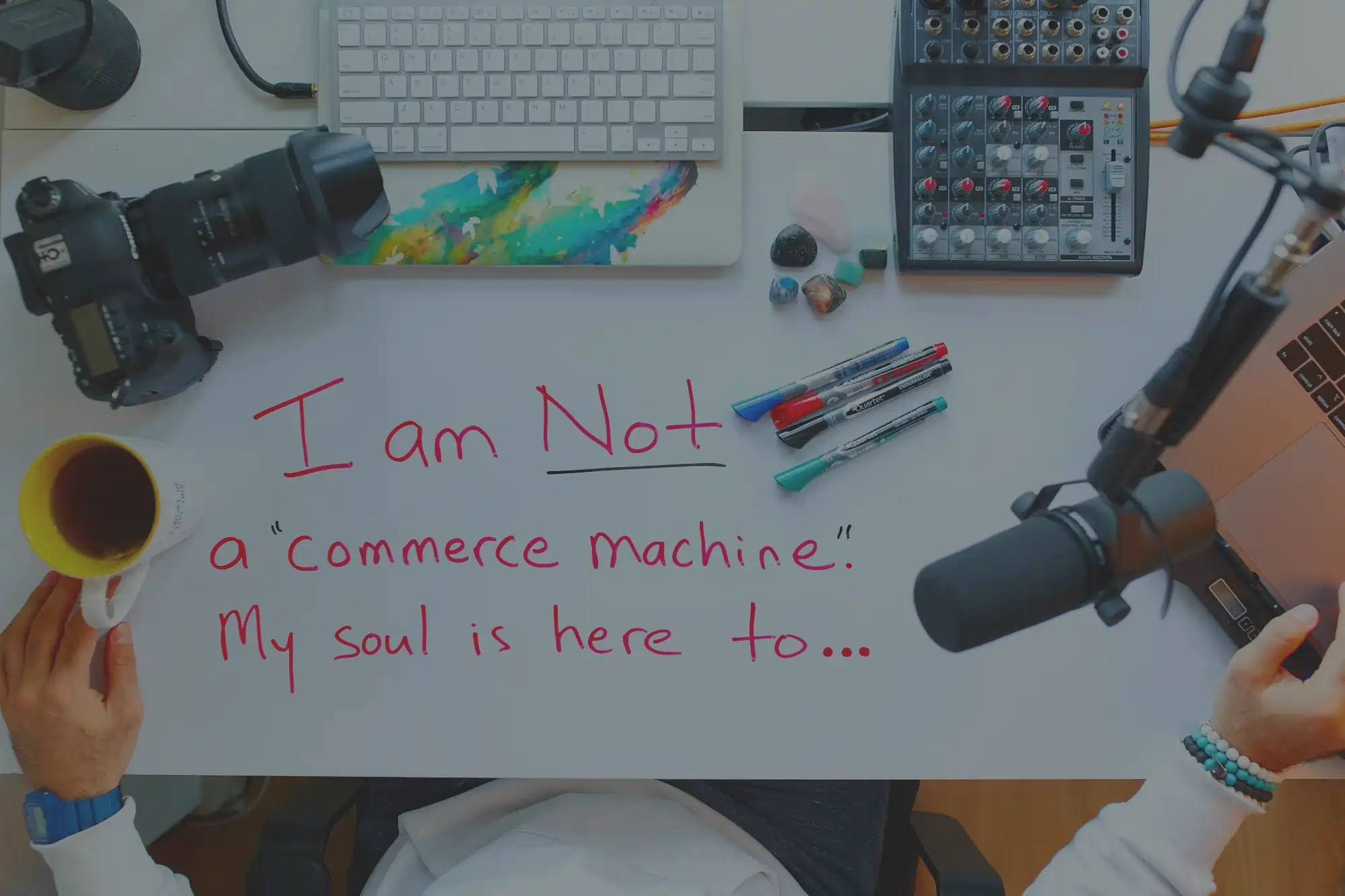 A writer at a desk with floating dialogue bubbles and cultural symbols surrounding them